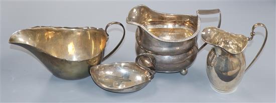 A George III cream jug (a.f.), one other silver cream jug, a silver sauceboat and a swan condiment.